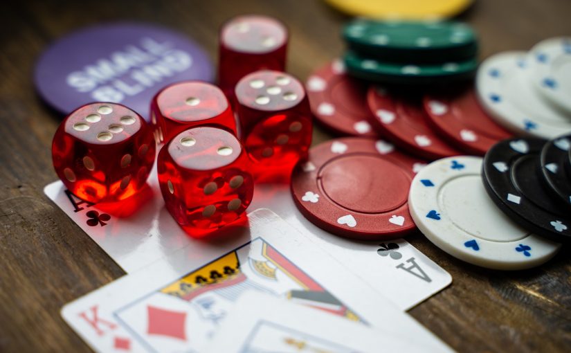 Spielkarten, Würfel und Chips auf einem Holztisch